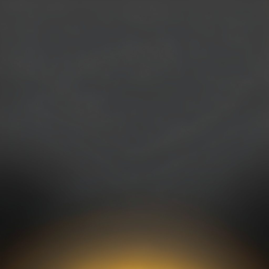 A soft, moody charcoal gradient background with a single warm mustard highlight near the lower edge, evoking a quiet workspace at dusk